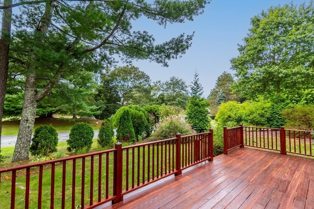 wooden terrace with a lawn