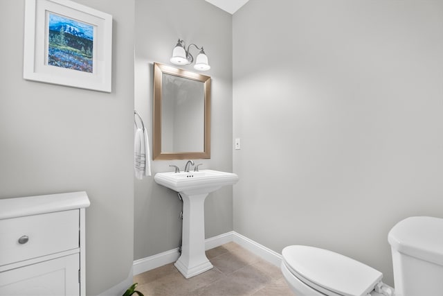 bathroom with tile patterned flooring and toilet