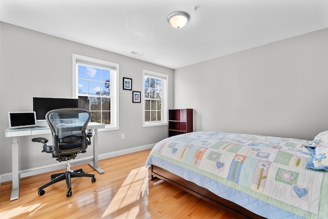 bedroom with hardwood / wood-style flooring