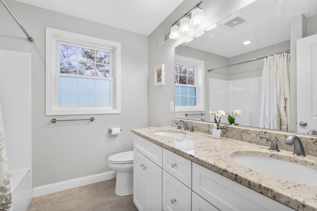 full bathroom featuring toilet, vanity, tile patterned floors, and a healthy amount of sunlight