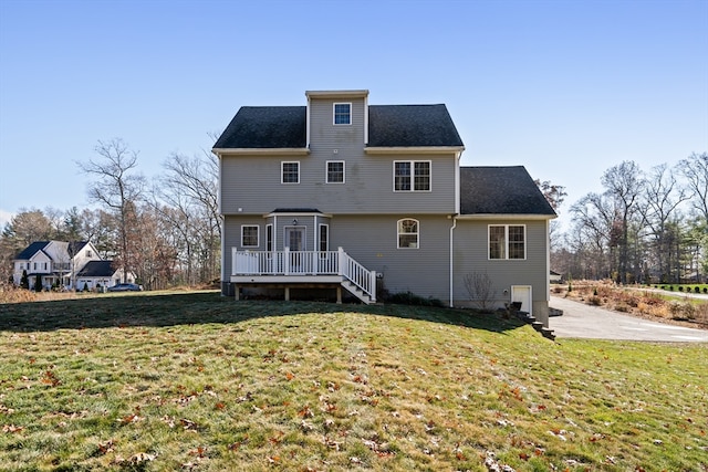 back of house with a yard and a deck