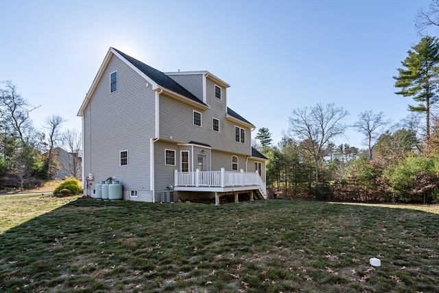 back of house with a lawn, central AC unit, and a wooden deck