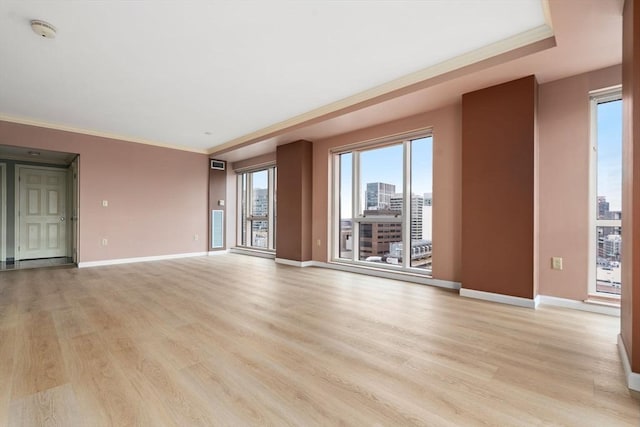 1 Nassau St Unit 2105, Boston, MA 02111 - unfurnished living room featuring ornamental molding, baseboards, and light wood-type flooring