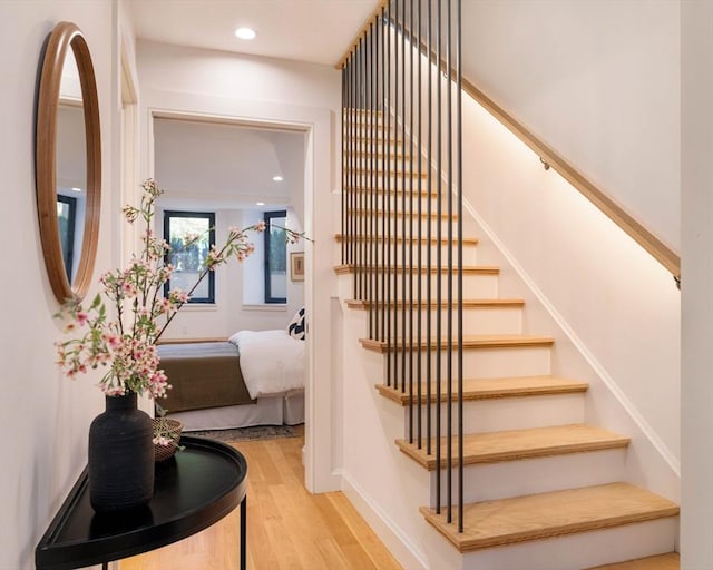 stairs featuring recessed lighting and wood finished floors