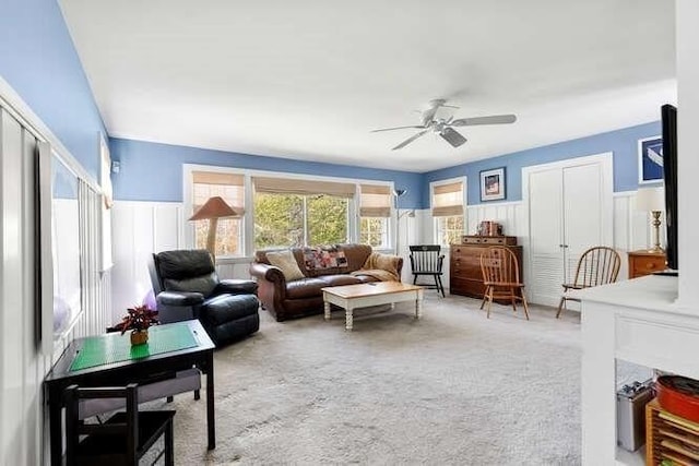 living area featuring ceiling fan and carpet flooring