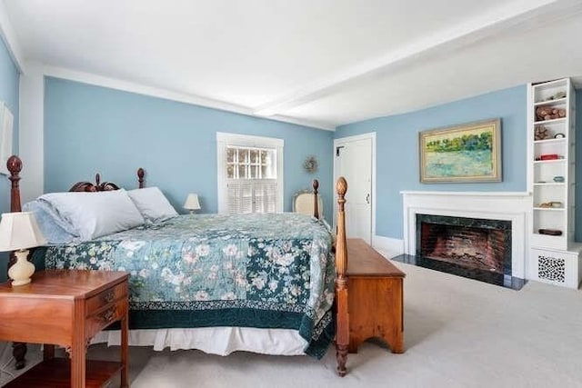 bedroom featuring a high end fireplace