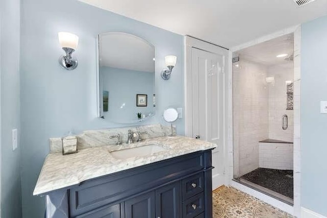 bathroom with a shower stall and vanity