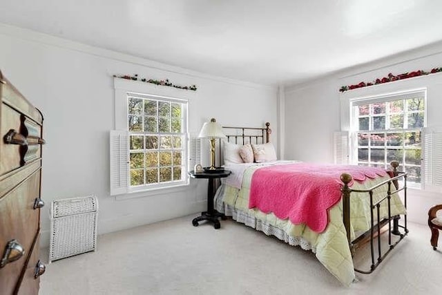 carpeted bedroom featuring ornamental molding