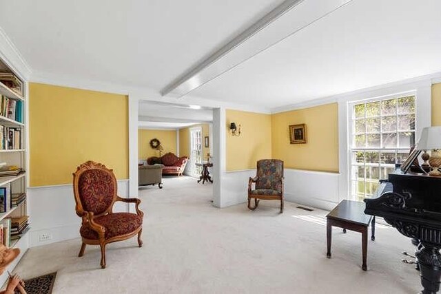 sitting room featuring plenty of natural light, carpet, and visible vents
