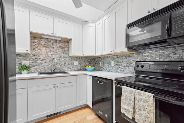 51 Nottingham Rd Unit 51, Grafton, MA 01519 - kitchen with black appliances, light countertops, decorative backsplash, light wood-style flooring, and white cabinets