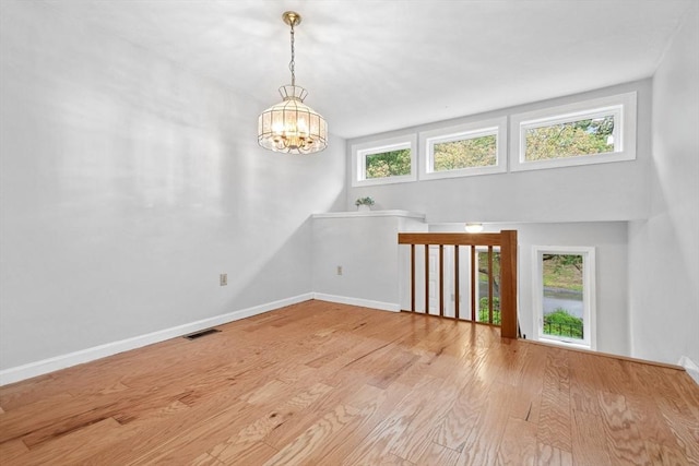 51 Nottingham Rd Unit 51, Grafton, MA 01519 - empty room featuring healthy amount of natural light, a chandelier, and wood finished floors
