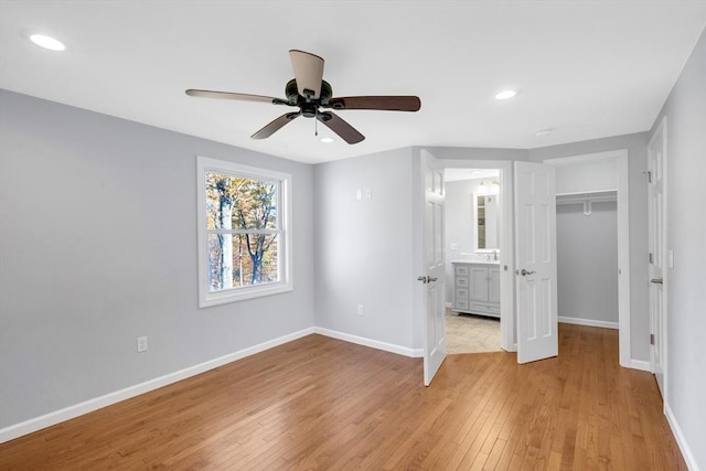 531 Old N Rd, Worthington, MA 01098 - unfurnished bedroom featuring light wood-style flooring, baseboards, recessed lighting, connected bathroom, and a ceiling fan