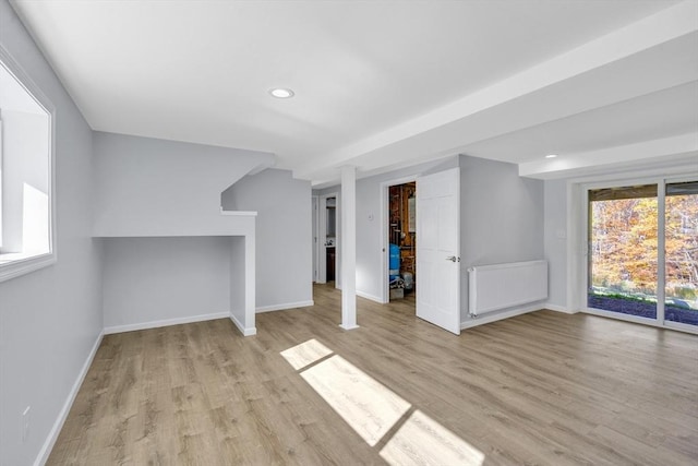 531 Old N Rd, Worthington, MA 01098 - unfurnished living room featuring radiator heating unit, wood finished floors, baseboards, and recessed lighting