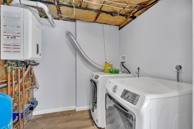 531 Old N Rd, Worthington, MA 01098 - laundry room with washer and clothes dryer, wood finished floors, water heater, and baseboards