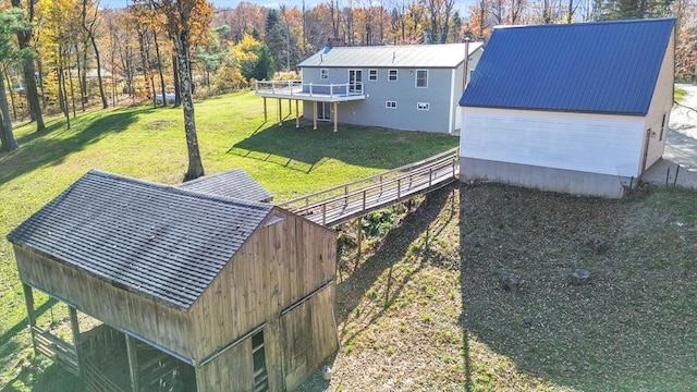 531 Old N Rd, Worthington, MA 01098 - rear view of house featuring a wooden deck, a lawn, and metal roof