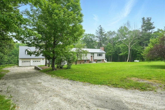 531 Old N Rd, Worthington, MA 01098 - view of front of home featuring a chimney, a front lawn, a detached garage, and metal roof
