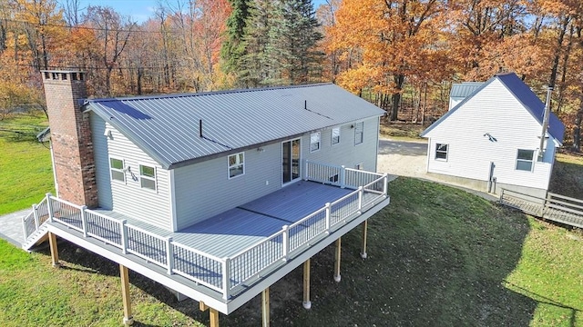 531 Old N Rd, Worthington, MA 01098 - back of property with a deck, a chimney, and metal roof