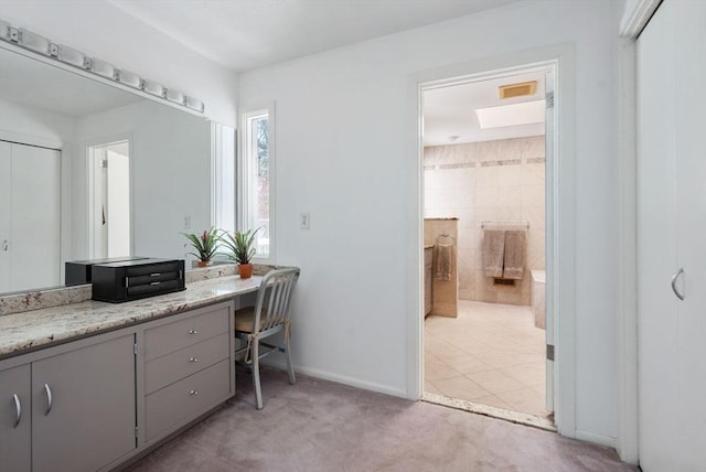 bathroom featuring vanity, visible vents, and baseboards