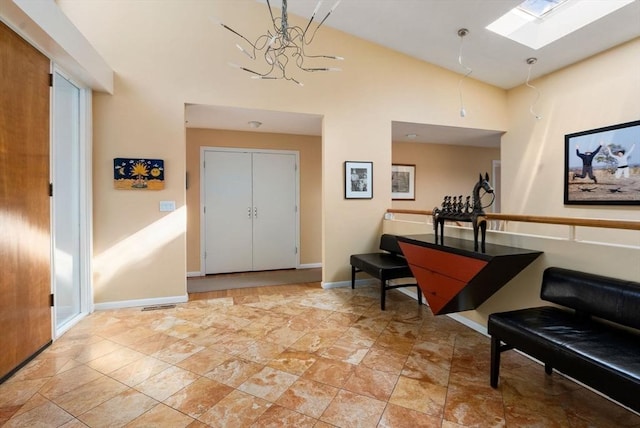 foyer with visible vents, high vaulted ceiling, and baseboards