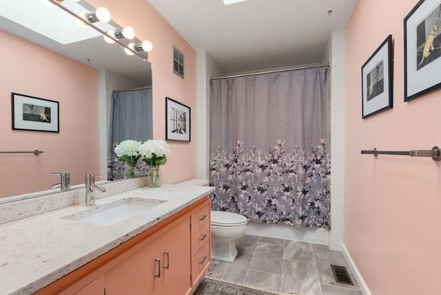 full bathroom featuring visible vents, toilet, a skylight, and vanity