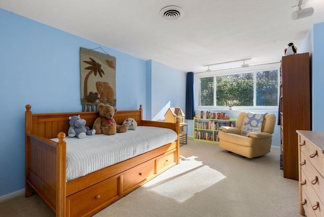 bedroom featuring visible vents, light colored carpet, and baseboards