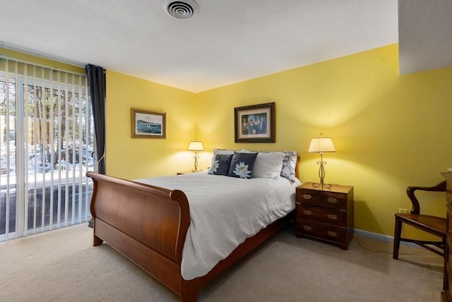 carpeted bedroom featuring baseboards and visible vents