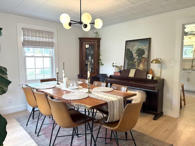 12 Wellington St, Buckland, MA 01370 - dining area with light wood-type flooring, crown molding, a chandelier, and baseboards