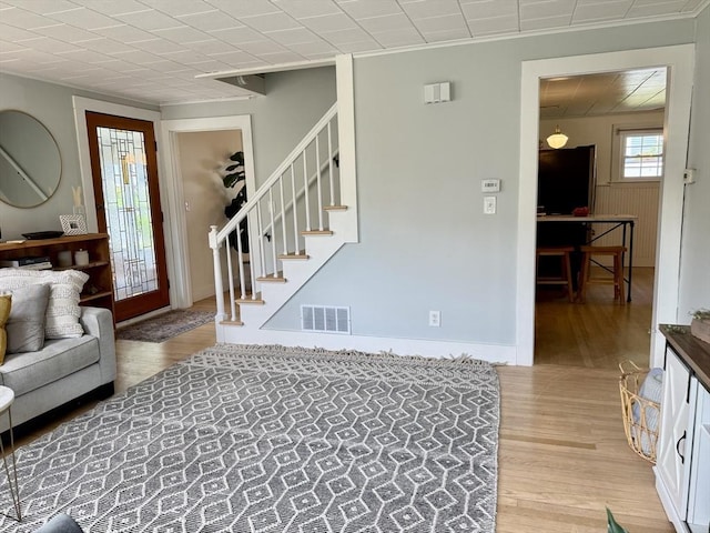 12 Wellington St, Buckland, MA 01370 - living room featuring light wood-type flooring, stairway, and crown molding