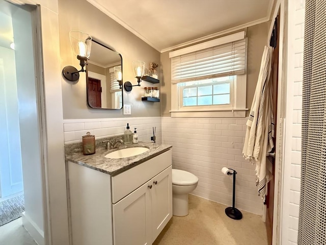 12 Wellington St, Buckland, MA 01370 - bathroom featuring tile walls, crown molding, vanity, toilet, and a wainscoted wall