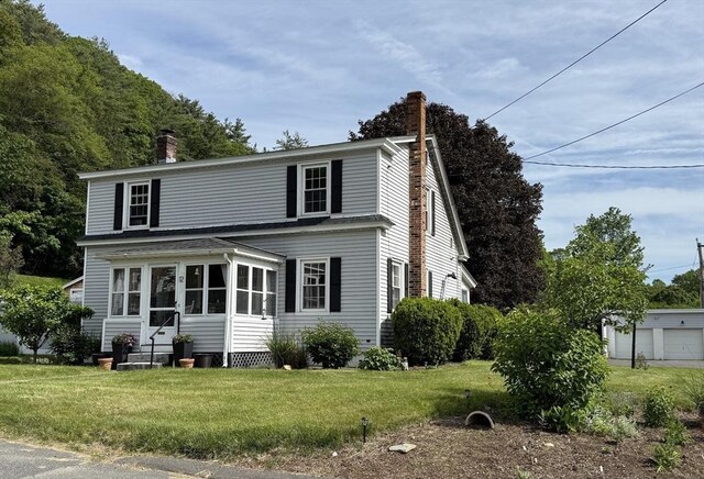 12 Wellington St, Buckland, MA 01370 - traditional home featuring a chimney, a front yard, and roof with shingles