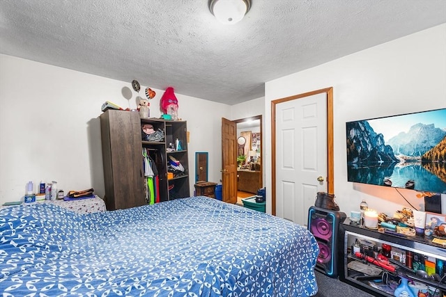 bedroom with carpet floors and a textured ceiling