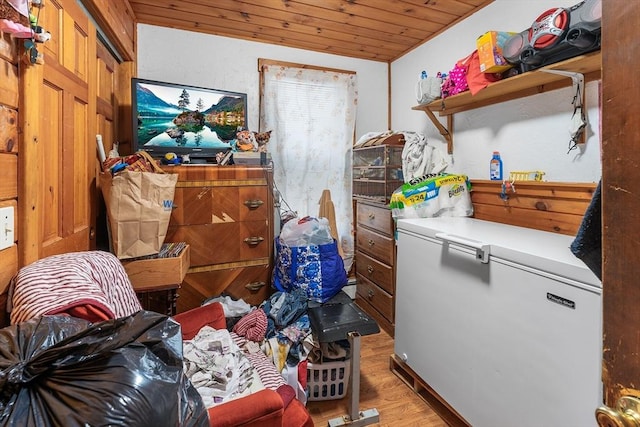 laundry area with light wood-style floors and wood ceiling