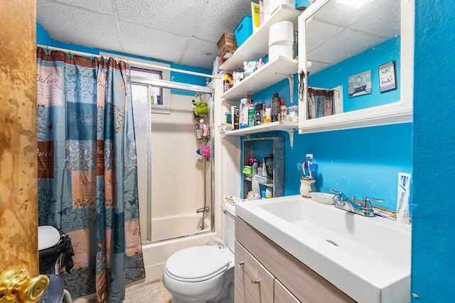 bathroom with vanity, a drop ceiling, shower / bath combo, and toilet