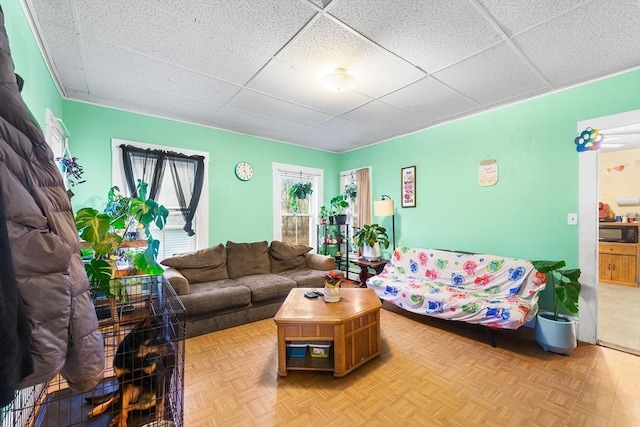 living room with a paneled ceiling