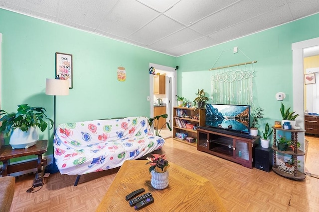 living room featuring a paneled ceiling