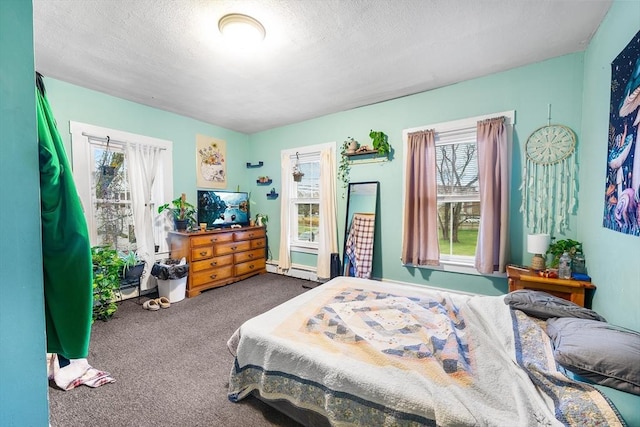 bedroom featuring a baseboard radiator, carpet, and a textured ceiling