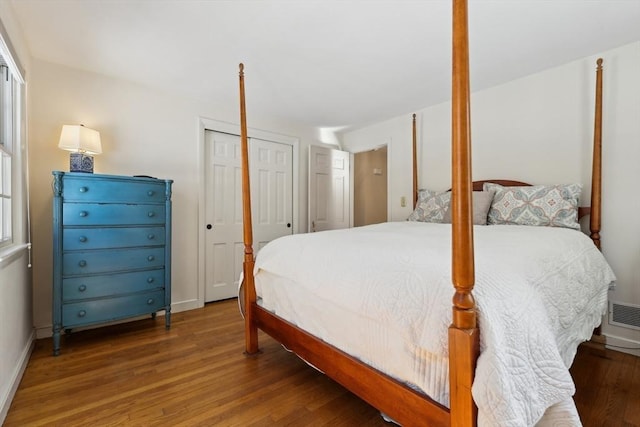 bedroom featuring baseboards and wood finished floors