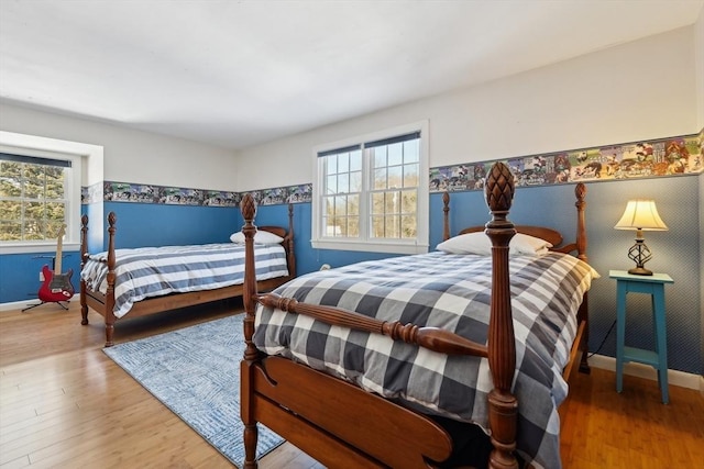 bedroom with baseboards and wood finished floors