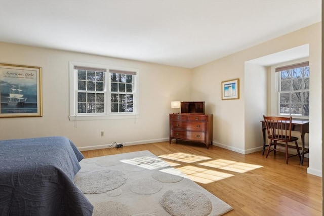 bedroom with wood finished floors and baseboards