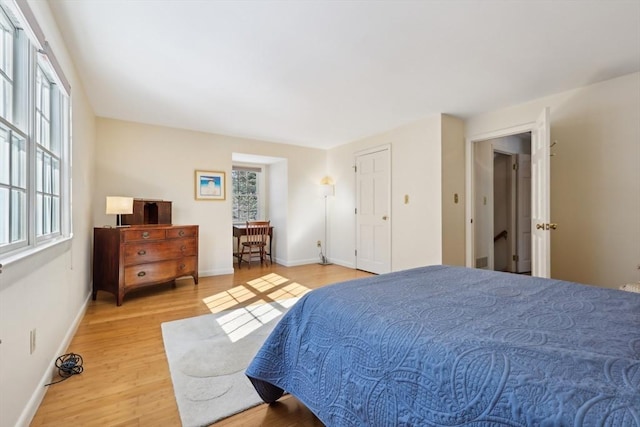 bedroom featuring baseboards and wood finished floors