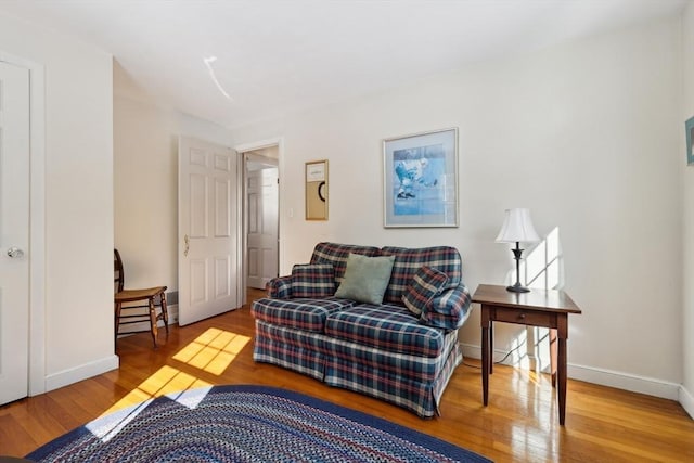 living area with wood finished floors and baseboards