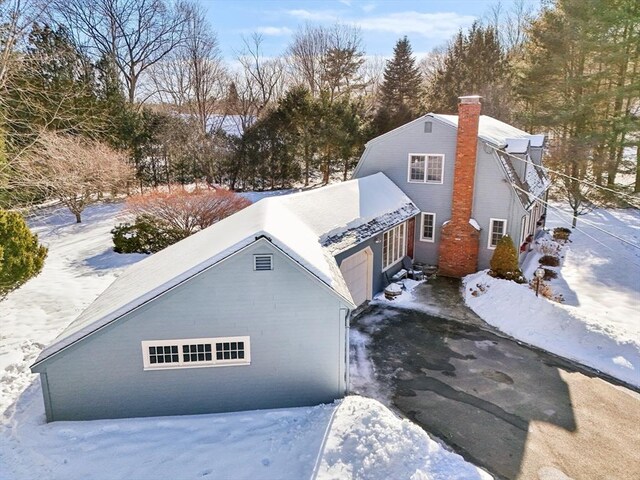 exterior space featuring driveway and a chimney