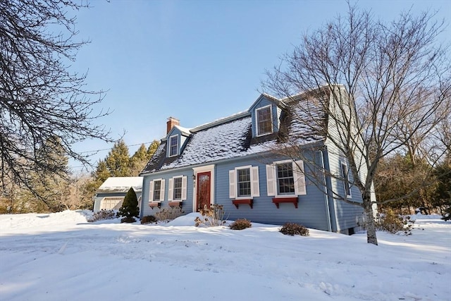 view of front facade with a garage and a chimney