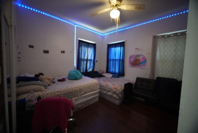 bedroom with wood finished floors and a ceiling fan