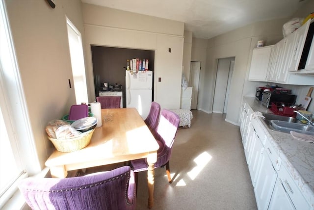 dining space featuring light colored carpet