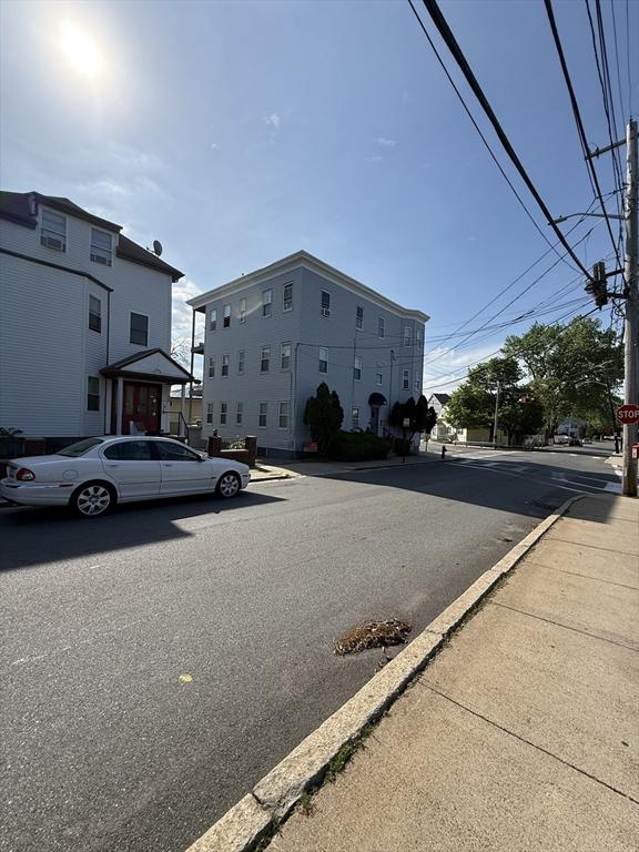 view of asphalt street with traffic signs