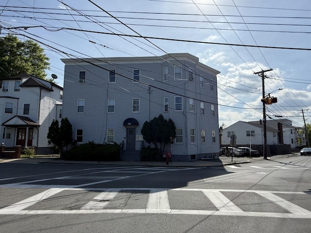 view of building exterior featuring uncovered parking