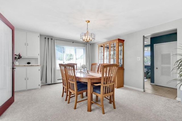 dining space featuring light carpet, a chandelier, baseboards, and a baseboard heating unit