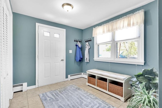 mudroom with a baseboard heating unit, baseboards, and tile patterned flooring