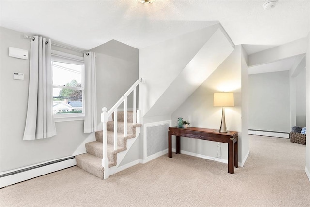 stairway featuring a baseboard heating unit, carpet floors, baseboard heating, and baseboards